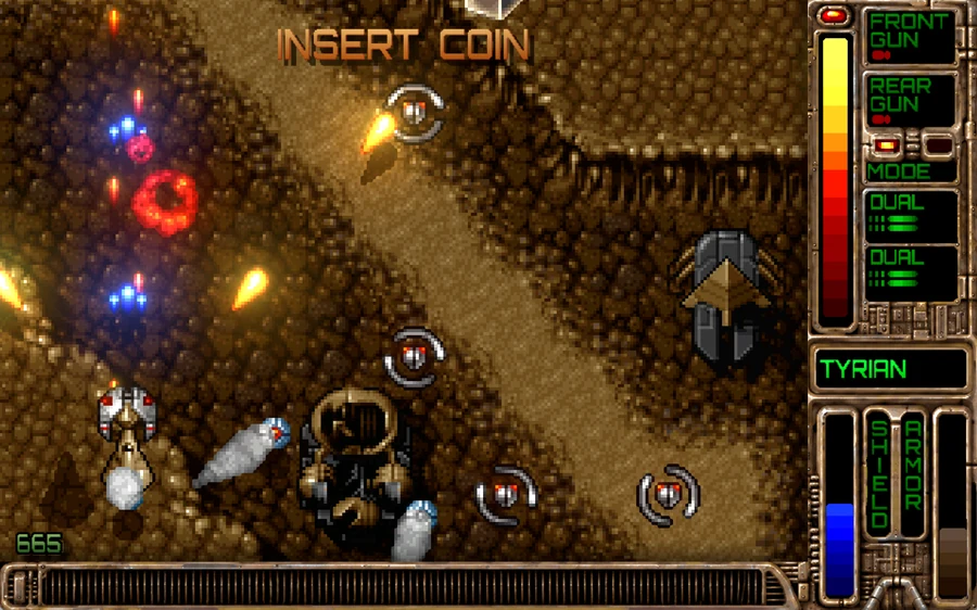 MetalTyrian in play: a ship flies over a desert canyon among enemy turrets, with the weapons panel on the right.